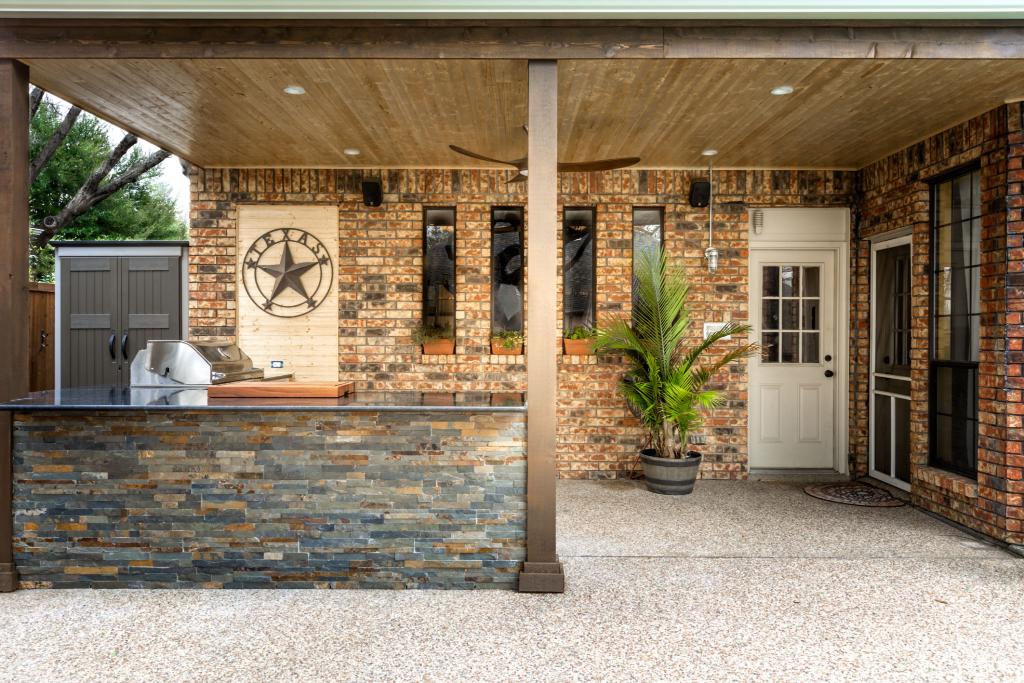 Custom outdoor kitchen and covered patio by SeeScape